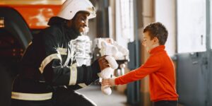 a boy talks to a firefighter