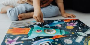 a kid completes a puzzle