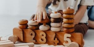 toddler hands play with counting manipulative