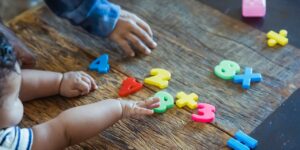 baby plays with number toys