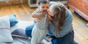 mom kisses toddler