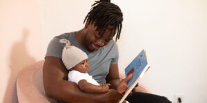 dad reading book to baby