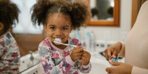 little girl brushing teeth