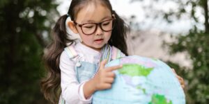 a girl holds a globe