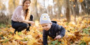 baby crawling on leaves