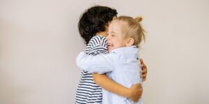 two kids hug