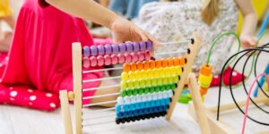 child using rainbow abacus