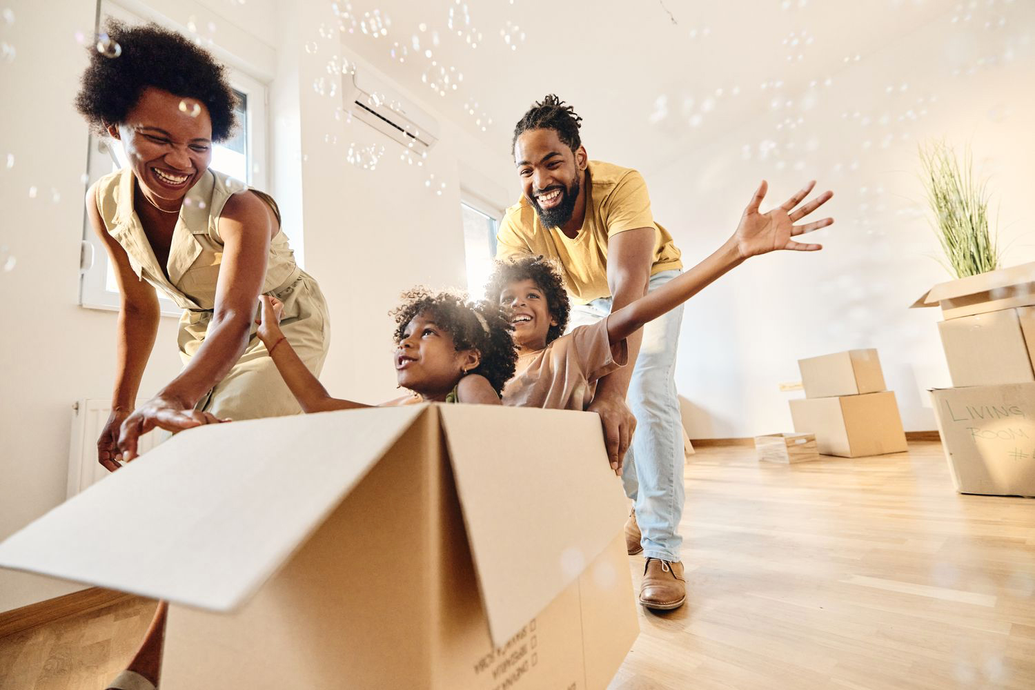 Family plays in boxes in their new home.